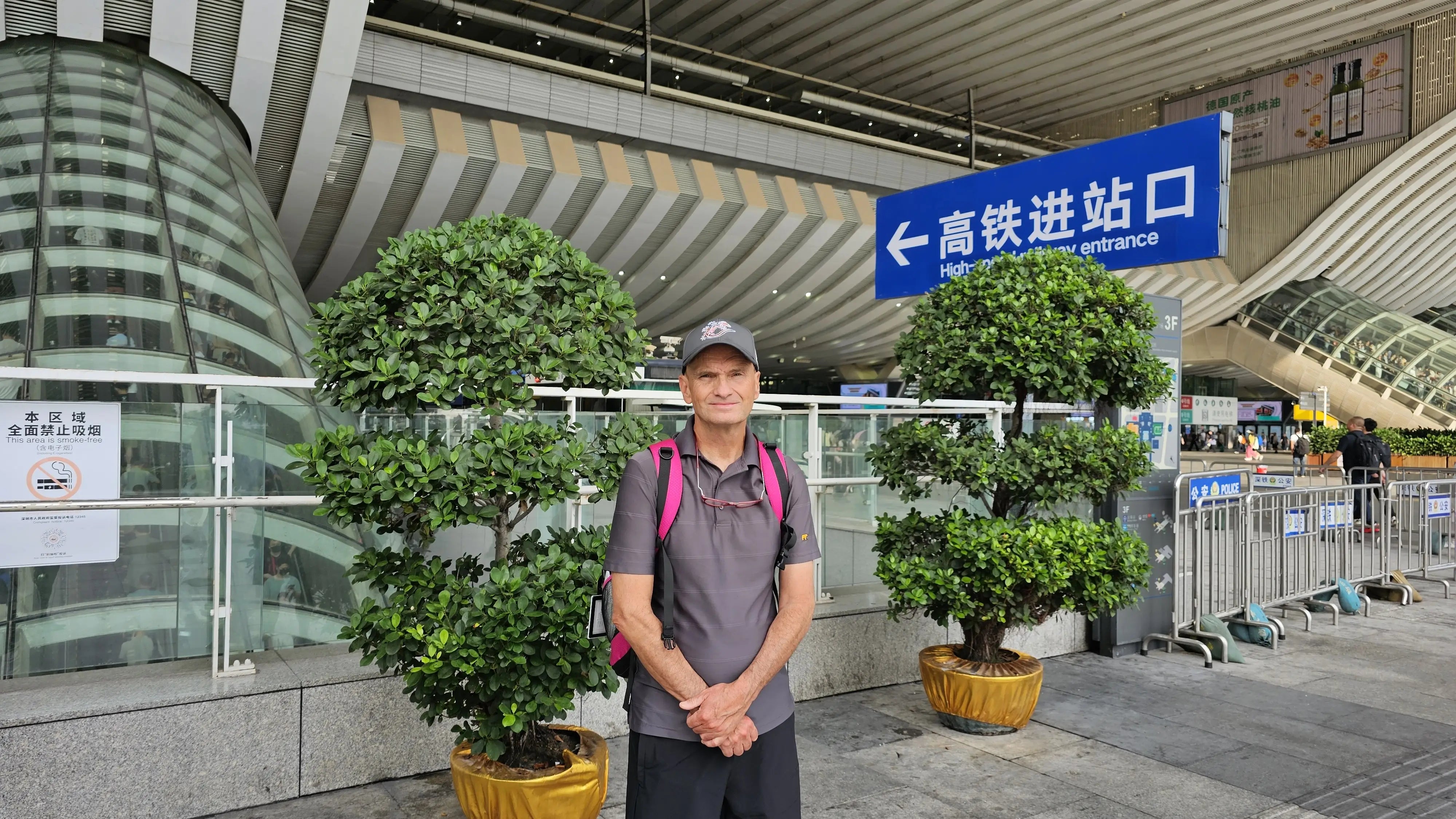 KOBO founder standing outside a high-speed rail station entrance while traveling to the factory, highlighting hands-on leadership and quality oversight.
